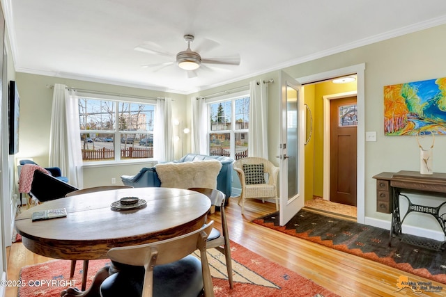 1008 Cordova St, Anchorage, AK 99501 - dining area with wood finished floors, crown molding, a ceiling fan, and baseboards