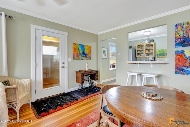 1008 Cordova St, Anchorage, AK 99501 - dining room with crown molding, baseboards, and wood finished floors
