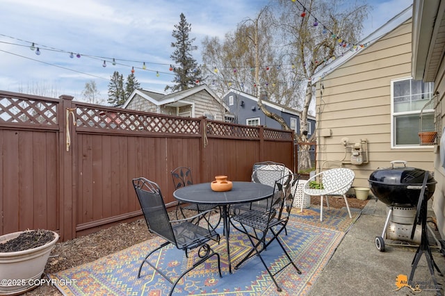 1008 Cordova St, Anchorage, AK 99501 - view of patio featuring outdoor dining area, a fenced backyard, and area for grilling