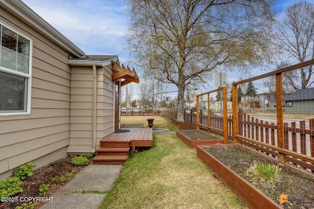 1008 Cordova St, Anchorage, AK 99501 - view of yard featuring a deck and a vegetable garden