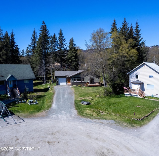 876 Lupine Ct, Homer, AK 99603 - bungalow-style home featuring driveway, an attached garage, a front yard, a deck, and a wooded view