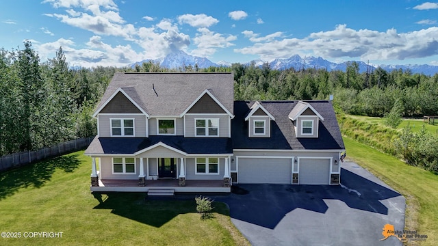 10588 E Nighthawk Cir, Palmer, AK 99645 - view of front of house featuring a porch, asphalt driveway, a mountain view, and an attached garage