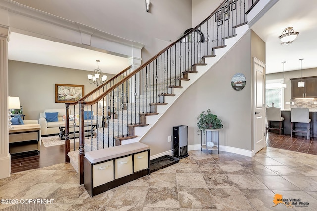 10588 E Nighthawk Cir, Palmer, AK 99645 - stairway with baseboards, a chandelier, and stone tile floors