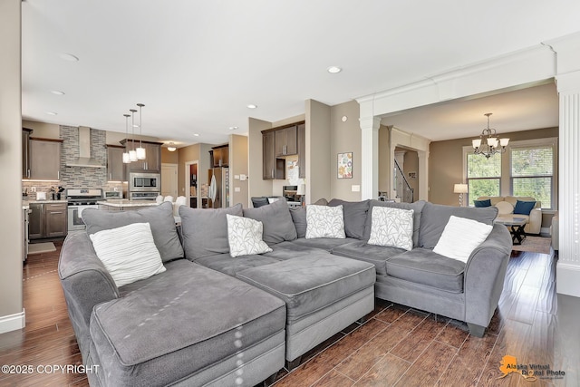 10588 E Nighthawk Cir, Palmer, AK 99645 - living area featuring a chandelier, dark wood-style flooring, ornate columns, and recessed lighting