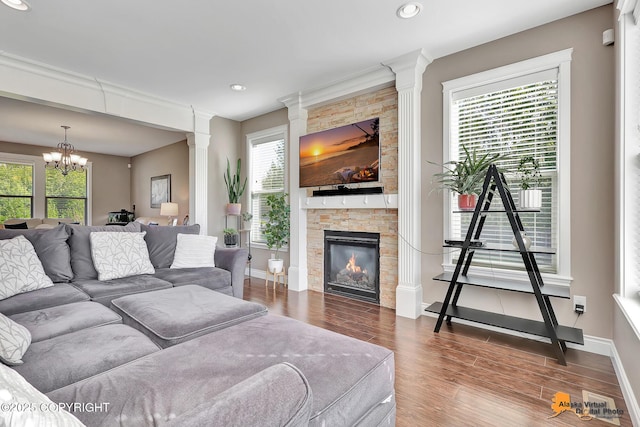 10588 E Nighthawk Cir, Palmer, AK 99645 - living area with wood finished floors, baseboards, decorative columns, a stone fireplace, and recessed lighting
