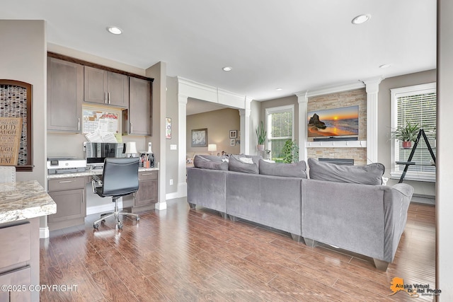 10588 E Nighthawk Cir, Palmer, AK 99645 - living area with plenty of natural light, decorative columns, wood finished floors, an office area, and recessed lighting