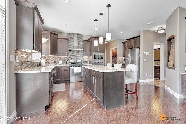 10588 E Nighthawk Cir, Palmer, AK 99645 - kitchen with appliances with stainless steel finishes, wall chimney range hood, a sink, a center island, and dark brown cabinets
