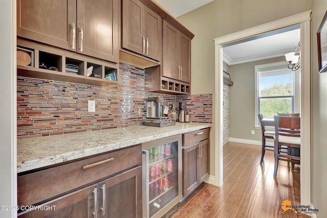 10588 E Nighthawk Cir, Palmer, AK 99645 - kitchen with beverage cooler, baseboards, backsplash, light wood finished floors, and ornamental molding