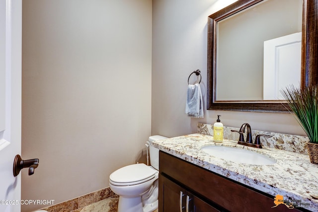 10588 E Nighthawk Cir, Palmer, AK 99645 - bathroom featuring vanity, toilet, and baseboards