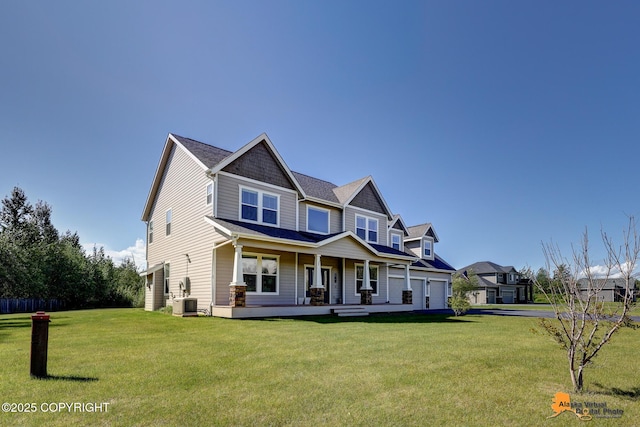 10588 E Nighthawk Cir, Palmer, AK 99645 - craftsman-style house featuring covered porch, a garage, a front yard, central air condition unit, and driveway
