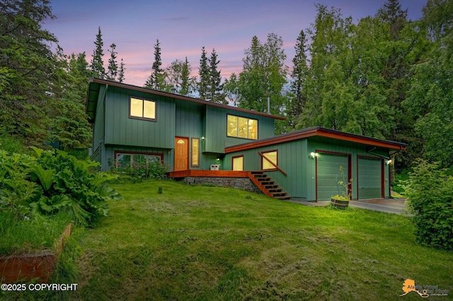 11721 Wranglers Way, Anchorage, AK 99516 - split foyer home featuring a front yard, a garage, and stairway