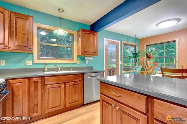 11721 Wranglers Way, Anchorage, AK 99516 - kitchen with appliances with stainless steel finishes, brown cabinetry, and pendant lighting
