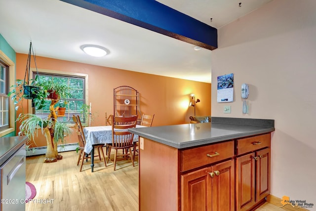 11721 Wranglers Way, Anchorage, AK 99516 - kitchen with baseboard heating, light wood-style floors, brown cabinetry, dark countertops, and stainless steel dishwasher