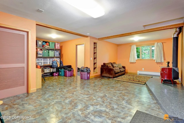 11721 Wranglers Way, Anchorage, AK 99516 - living area with a wood stove and a baseboard heating unit