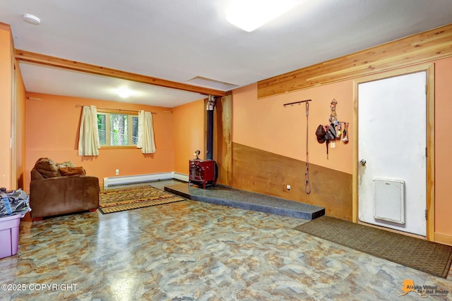 11721 Wranglers Way, Anchorage, AK 99516 - unfurnished room with a baseboard heating unit, a wood stove, a smoke detector, and tile patterned floors