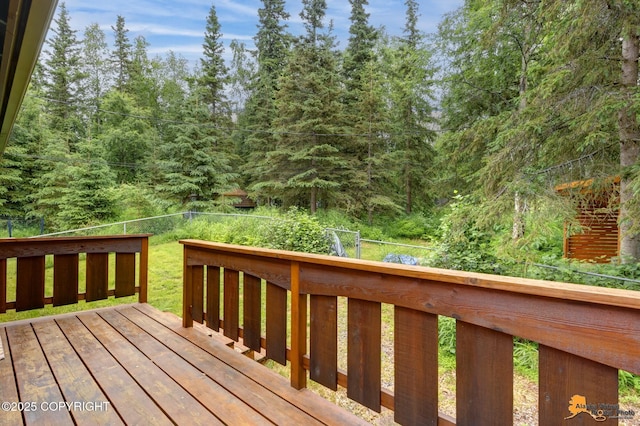 11721 Wranglers Way, Anchorage, AK 99516 - wooden terrace with a fenced backyard and a view of trees
