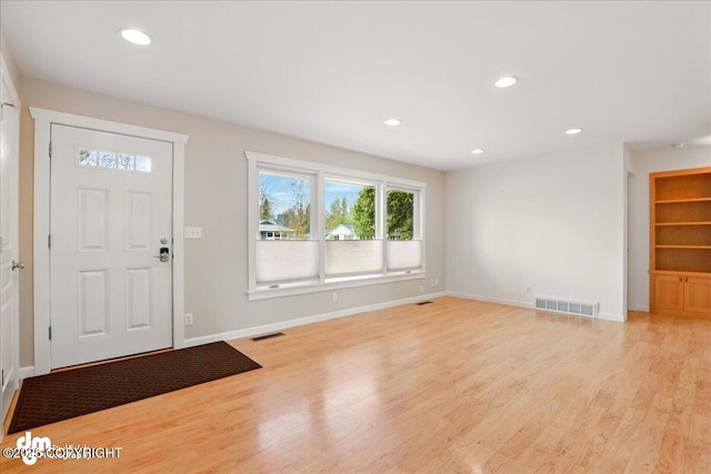 entryway with light wood-style floors, baseboards, and recessed lighting