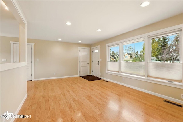 entryway featuring light wood-style floors, baseboards, and recessed lighting