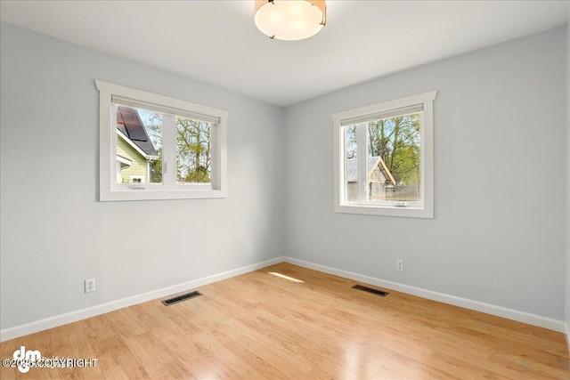 unfurnished room with wood finished floors and baseboards