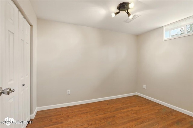 empty room with wood finished floors and baseboards