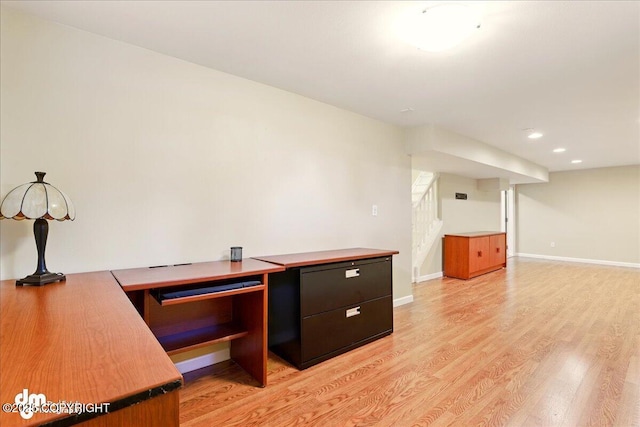 unfurnished office with light wood finished floors, recessed lighting, and baseboards