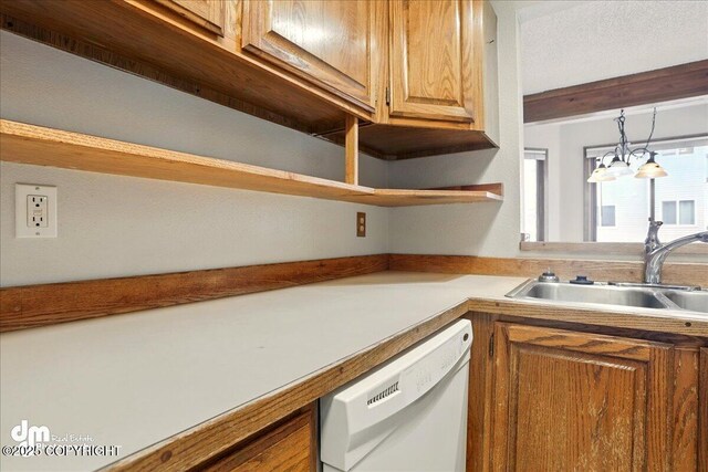 kitchen with dishwasher, a sink, open shelves, light countertops, and a chandelier