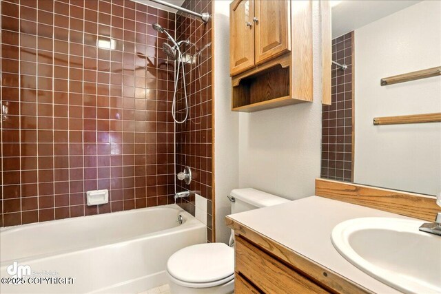 bathroom featuring toilet, vanity, and  shower combination
