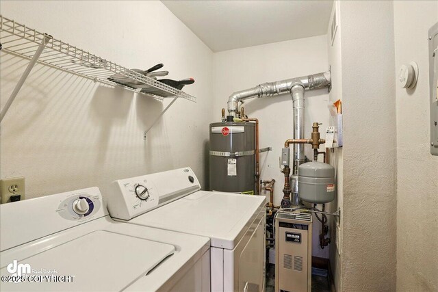 washroom with washing machine and dryer, secured water heater, and a heating unit