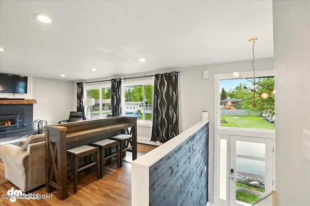 1831 S Salem Dr, Anchorage, AK 99508 - living area featuring wood finished floors, a fireplace, recessed lighting, and baseboard heating