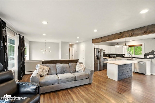 1831 S Salem Dr, Anchorage, AK 99508 - living area with a chandelier, recessed lighting, wood finished floors, and a baseboard heating unit