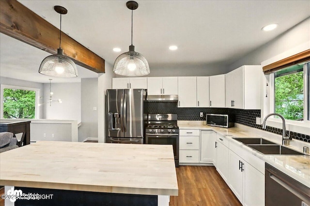 1831 S Salem Dr, Anchorage, AK 99508 - kitchen featuring appliances with stainless steel finishes, a sink, wood counters, plenty of natural light, and recessed lighting