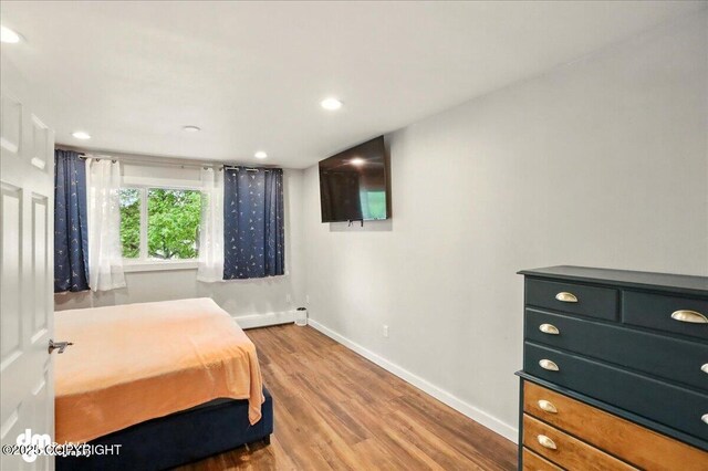 1831 S Salem Dr, Anchorage, AK 99508 - bedroom featuring baseboards, wood finished floors, baseboard heating, and recessed lighting