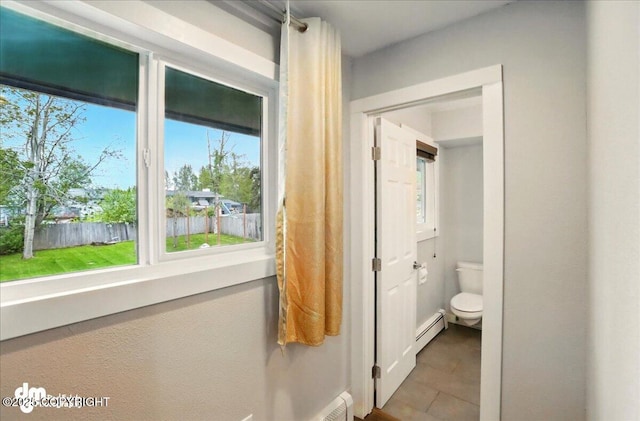 1831 S Salem Dr, Anchorage, AK 99508 - bathroom featuring toilet, a baseboard heating unit, and tile patterned floors