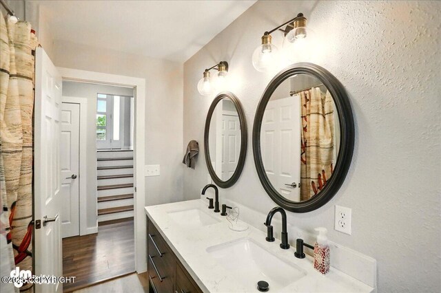 1831 S Salem Dr, Anchorage, AK 99508 - full bathroom featuring double vanity and wood finished floors