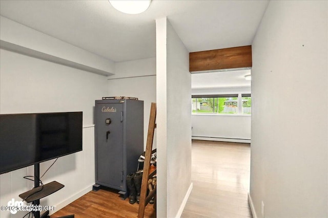 1831 S Salem Dr, Anchorage, AK 99508 - exercise area featuring a baseboard radiator, wood finished floors, and baseboards