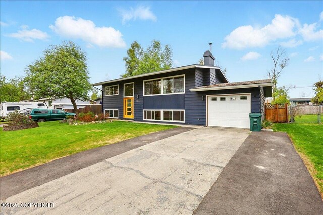 1831 S Salem Dr, Anchorage, AK 99508 - view of front facade with an attached garage, asphalt driveway, and a chimney