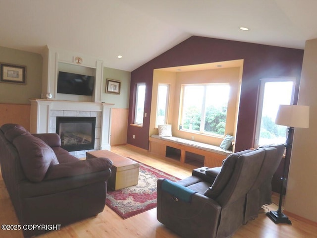 2340 E End Rd, Homer, AK 99603 - living area with light wood finished floors, vaulted ceiling, and a tiled fireplace