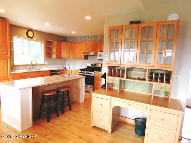 2340 E End Rd, Homer, AK 99603 - kitchen featuring gas range, a center island with sink, under cabinet range hood, light wood-type flooring, and recessed lighting