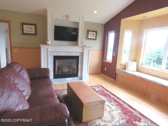 2340 E End Rd, Homer, AK 99603 - living room with plenty of natural light, vaulted ceiling, a tile fireplace, wood finished floors, and wainscoting