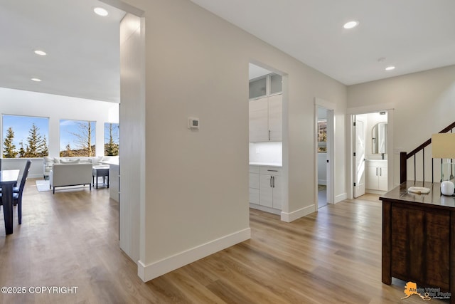 8236 Byron Dr, Anchorage, AK 99516 - hallway featuring light wood-style floors, recessed lighting, stairs, and baseboards