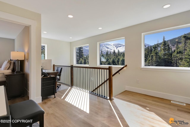 8236 Byron Dr, Anchorage, AK 99516 - hall featuring an upstairs landing, healthy amount of natural light, light wood-type flooring, and recessed lighting
