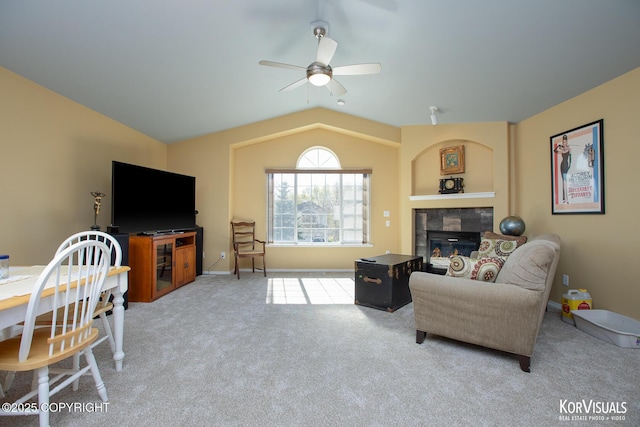 3025 Seclusion Cove Dr # 43, Anchorage, AK 99515 - living room featuring a ceiling fan, carpet, a tile fireplace, vaulted ceiling, and baseboards
