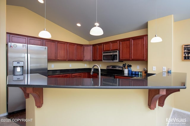 3025 Seclusion Cove Dr # 43, Anchorage, AK 99515 - kitchen featuring stainless steel appliances, vaulted ceiling, dark countertops, hanging light fixtures, and a peninsula