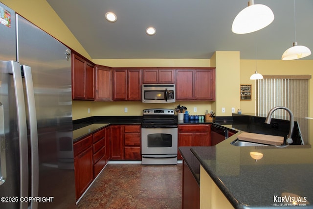 3025 Seclusion Cove Dr # 43, Anchorage, AK 99515 - kitchen featuring appliances with stainless steel finishes, a sink, dark brown cabinets, dark countertops, and recessed lighting