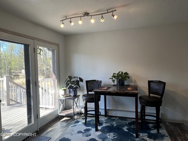 981 E Susitna Dr, Wasilla, AK 99654 - dining space featuring baseboards, wood finished floors, and a textured ceiling