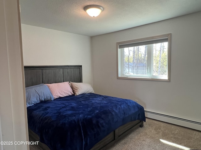 981 E Susitna Dr, Wasilla, AK 99654 - bedroom featuring carpet, a baseboard heating unit, and a textured ceiling