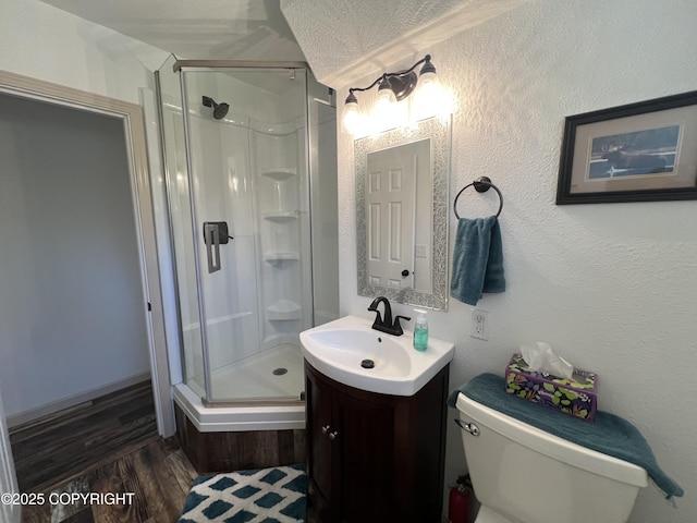 981 E Susitna Dr, Wasilla, AK 99654 - full bath with a shower stall, vanity, toilet, and wood finished floors