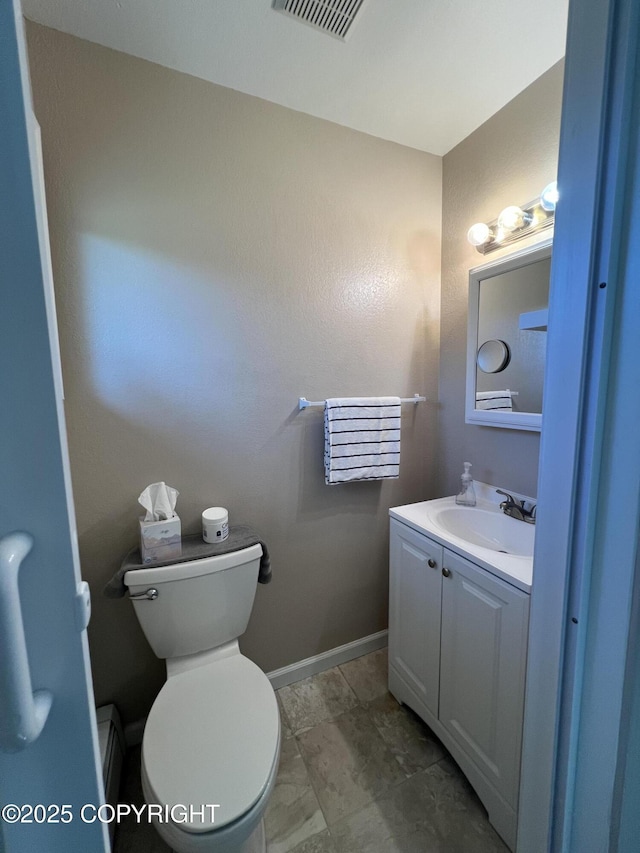 981 E Susitna Dr, Wasilla, AK 99654 - half bathroom featuring toilet, vanity, and baseboards