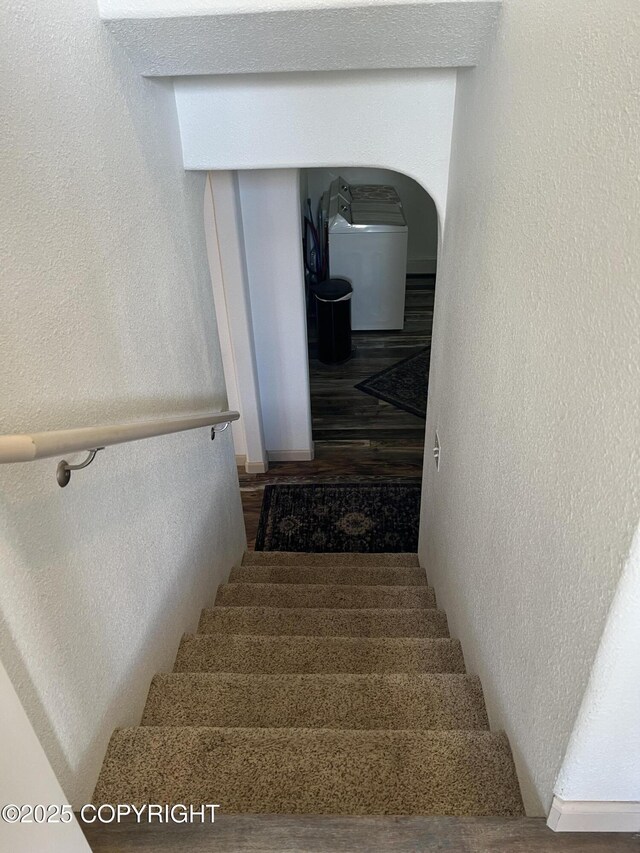 981 E Susitna Dr, Wasilla, AK 99654 - staircase featuring a textured wall, wood finished floors, and arched walkways