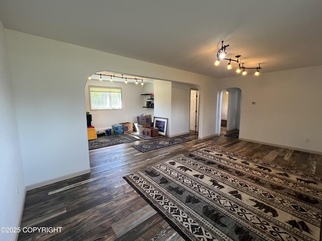 981 E Susitna Dr, Wasilla, AK 99654 - living area featuring arched walkways, track lighting, wood finished floors, and baseboards